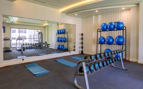 a gym with blue boxing equipment and a mirror at Sunset Jeddah in Jeddah