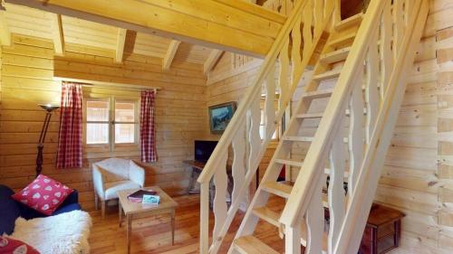 a living room with stairs in a log cabin at Aktivurlaub am Großglockner in der Hütte Schlosswirt Chalet III by FeWoplan in Großkirchheim
