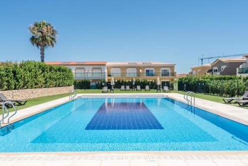 a swimming pool in front of a building at Casa Mapie - Boavista Resort in Lagos