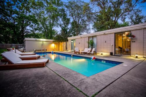 a swimming pool with lounge chairs and a house at The Palms Mirage House home in Millman