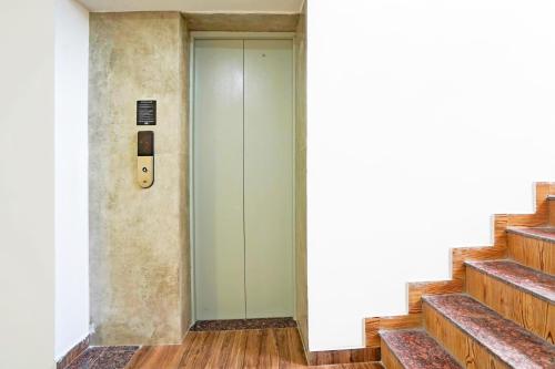 a elevator in a building with stairs at Super Hotel O Sunshine Villa in Nagpur