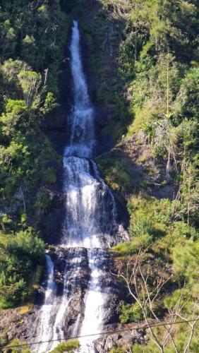 a waterfall in the middle of a forest at Bel horizon M&J location voiture sur demande in Saint-Paul