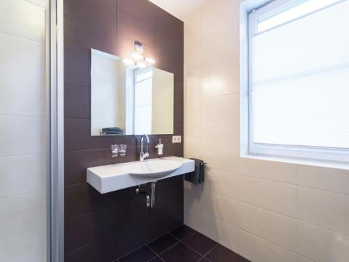 a bathroom with a white sink and a mirror at Apartment in Leogang near Ski Slopes in Leogang