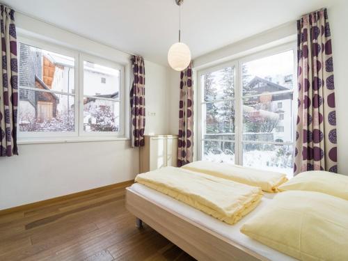 a bedroom with two beds and two windows at Apartment in Leogang near Ski Slopes in Leogang