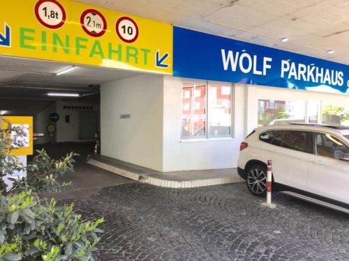 a white car parked in front of a walmart store at Unperfekthotel CoWorkingHotel in Essen