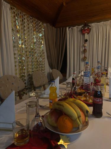 a plate of bananas and oranges on a table at Спа Комплекс Ливадите in Deredzhik-Kʼoy
