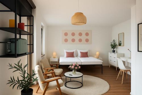 a living room with a bed and a table at STAYS Bodensee Apartments in Stetten