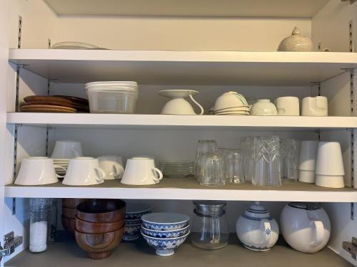 a shelf filled with dishes and other items at AKUNOURA HUIS - Vacation STAY 10922 in Nagasaki