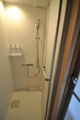 a bathroom with a shower with a shower curtain at AKUNOURA HUIS - Vacation STAY 10922 in Nagasaki