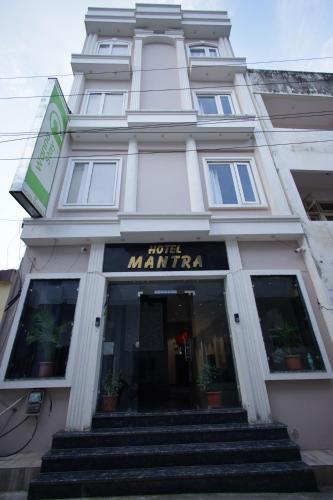 a white building with stairs in front of it at Mantra inn by Natures Hook in Haridwār