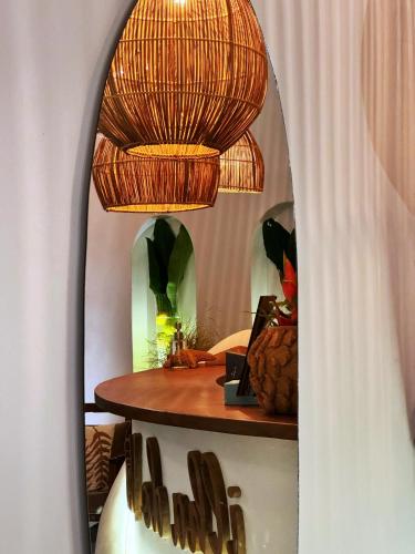 a room with a table and a mirror at Pousada Ilha do Vento in São Miguel do Gostoso
