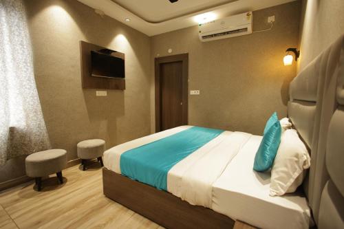 a hotel room with a bed and a television at Mantra inn by Natures Hook in Haridwār