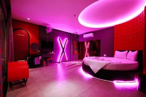 a bedroom with a bed with purple lights in it at khách sạn tina 5 in Can Tho