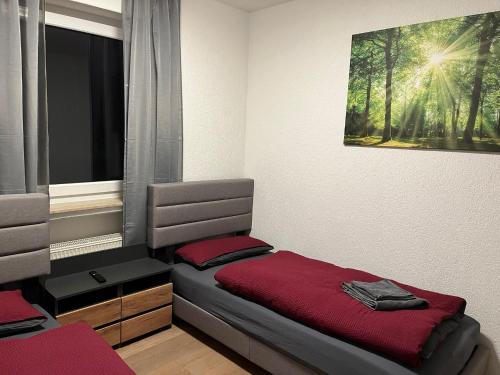 a bedroom with a bed with a red blanket at HausOase Zimmervermietung Gergert in Schwäbisch Hall
