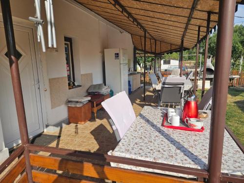 an outdoor table and chairs under a pavilion at Podgoria Guesthouse- Camere de închiriat in Oradea