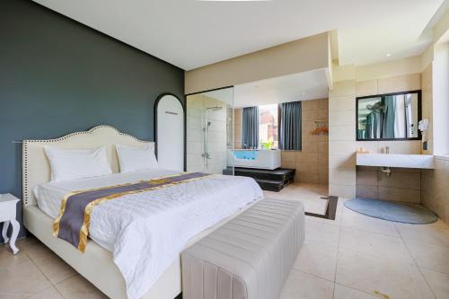 a bedroom with a large bed and a bathroom at khách sạn tina 5 in Can Tho