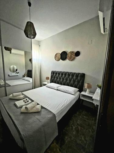 a bedroom with a large bed with two towels on it at Clio's house in Áyioi Dhéka