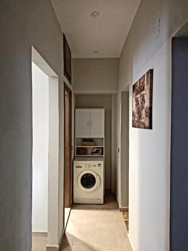 a kitchen with a washer and dryer in a room at Clio's house in Áyioi Dhéka