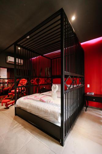 a bedroom with a black bunk bed with red walls at khách sạn tina 5 in Can Tho