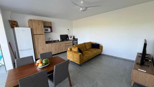 a living room with a table and a couch at Alizé Cap in Sainte-Anne