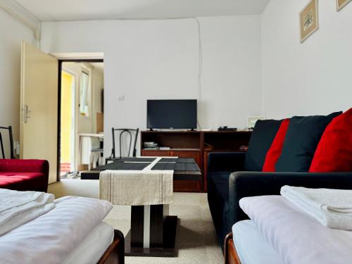 a living room with two couches and a tv at Privát Ruženka in Liptovský Mikuláš