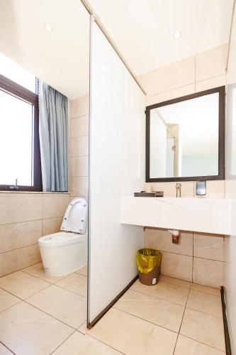 a bathroom with a sink and a toilet at khách sạn tina 5 in Can Tho