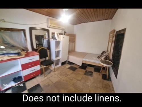 a small room with a bed and a desk with a mirror at La Casetta in Nazareth