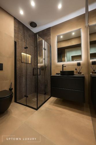 a bathroom with a shower and a sink and a mirror at XIII 1d in Lisbon