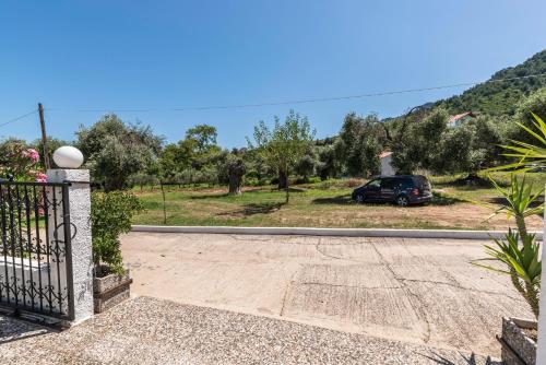 a villa with a car parked in a driveway at Hotel Sylvia in Kinira