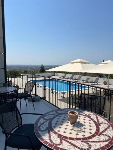 a patio with a table and chairs and a pool at Vila Slavonika in Slavonski Brod