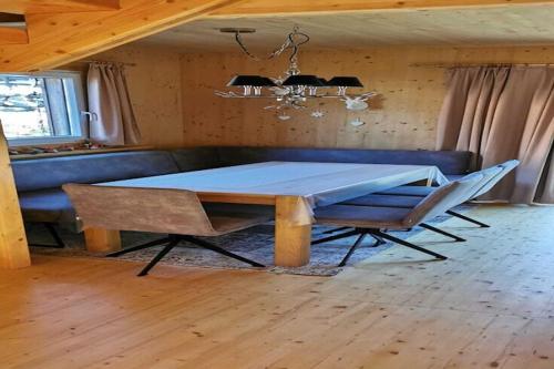 a dining room with a blue table and a couch at Chalet in Hohentauern near Ski Lift in Hohentauern