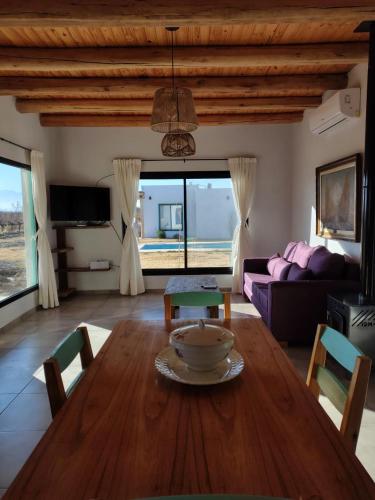 a living room with a wooden table and a couch at Finca Rosablanca in Tunuyán