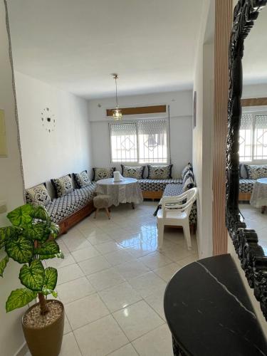 a living room with a couch and a table at Al hoceima in Al Hoceïma