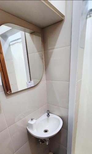 a bathroom with a sink and a mirror at Apto Inteiro Centro Sta Casa 200m WIFI Perto de Tudo até 4 pessoas in Porto Alegre
