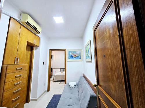 a living room with a couch and a wooden door at Apto Inteiro Centro Sta Casa 200m WIFI Perto de Tudo até 4 pessoas in Porto Alegre