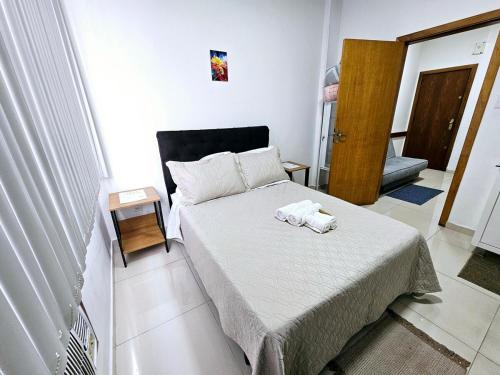 a small bedroom with a bed with a towel on it at Apto Inteiro Centro Sta Casa 200m WIFI Perto de Tudo até 4 pessoas in Porto Alegre