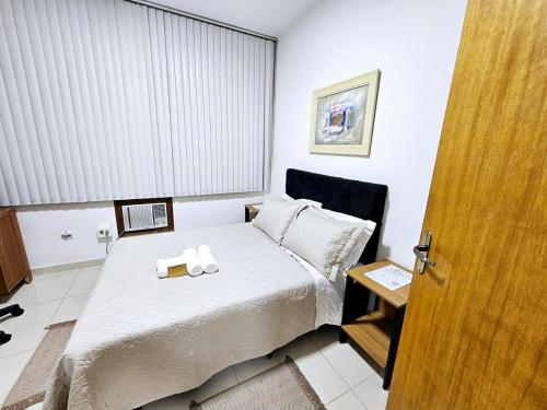 a bedroom with a bed with a towel on it at Apto Inteiro Centro Sta Casa 200m WIFI Perto de Tudo até 4 pessoas in Porto Alegre