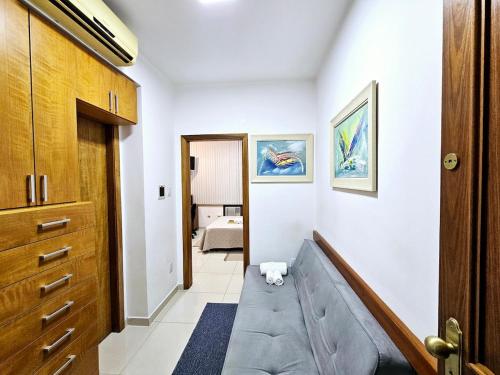 a living room with a couch and a bedroom at Apto Inteiro Centro Sta Casa 200m WIFI Perto de Tudo até 4 pessoas in Porto Alegre
