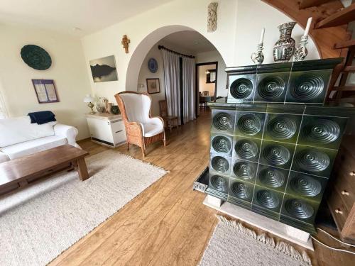 a large living room with a bed and a couch at Szaletli in Tihany