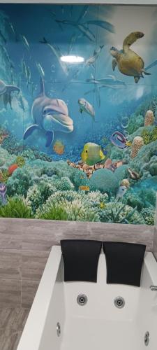 a bedroom with a mural of a underwater world at Coraline Pereybere in Cap Malheureux