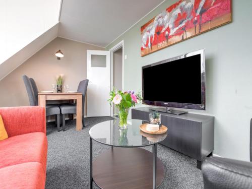 a living room with a tv and a table at Peaceful Family Home in Elim in Elim