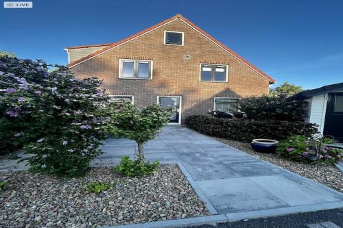 a brick house with a driveway in front of it at Peaceful Family Home in Elim in Elim