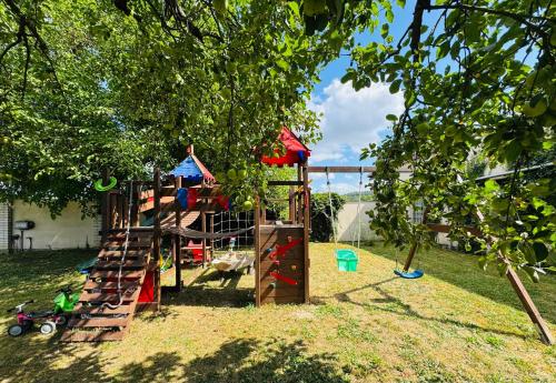 a playground with a slide in a yard at Rodinný apartmán se saunou, bazénem a hřištěm Staňkov in Staňkov