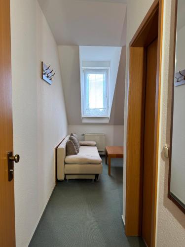 a small room with a bed and a window at Hotel am Bergl in Schweinfurt