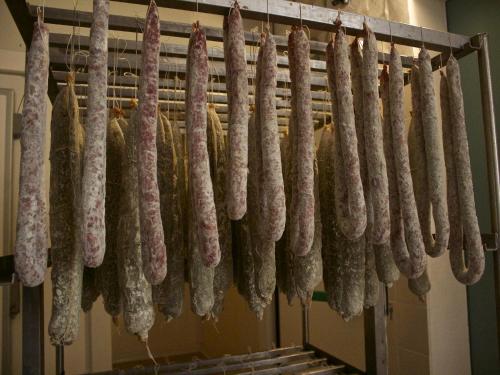 a bunch of sausages hanging on a rack at Rural Retreat in Sassoleone in Sassoleone