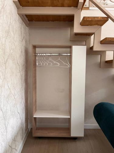 a room with a staircase with white shelves at Svezhest/Свежесть in Kok-Shoky