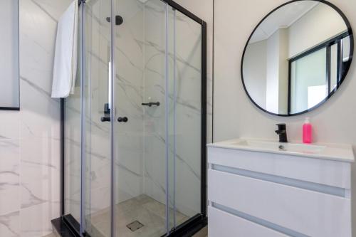a bathroom with a glass shower and a sink at AlimamaSpaces The Chelsea's Munyaka in Midrand