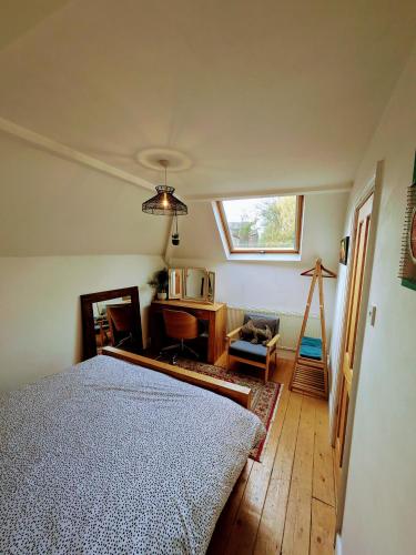 a bedroom with a bed and a desk and a window at Detached House with Gated Parking in Whalley Range, Near Manchester City Centre in Manchester