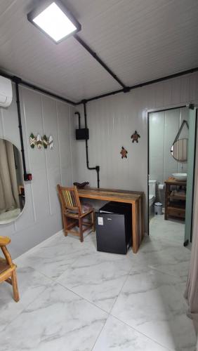 a living room with a table and a television at Aldeia Mar in Bertioga