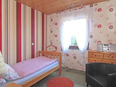 a small bedroom with a bed and a window at Ferienwohnung Reitz Urlaub In Der Heimat Der Brüder Grimm in Fritzlar